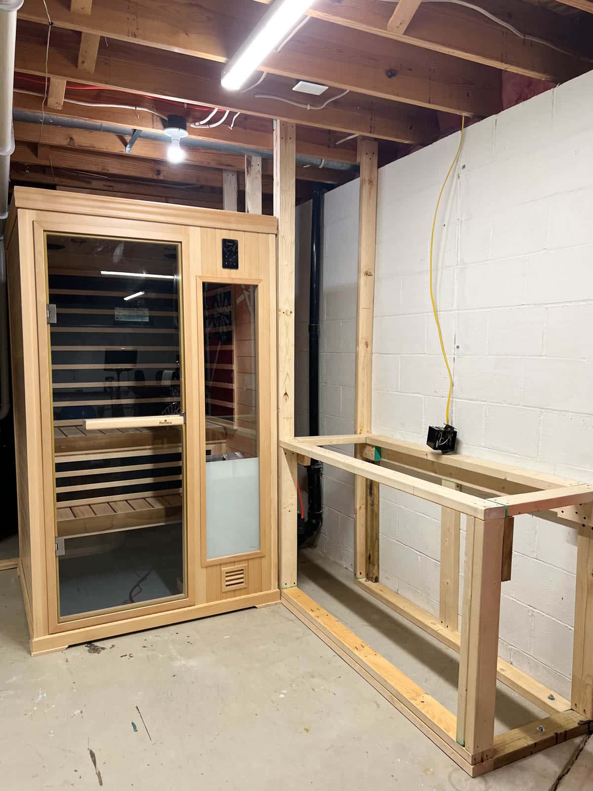 sauna and framed wood rectangle in basement.