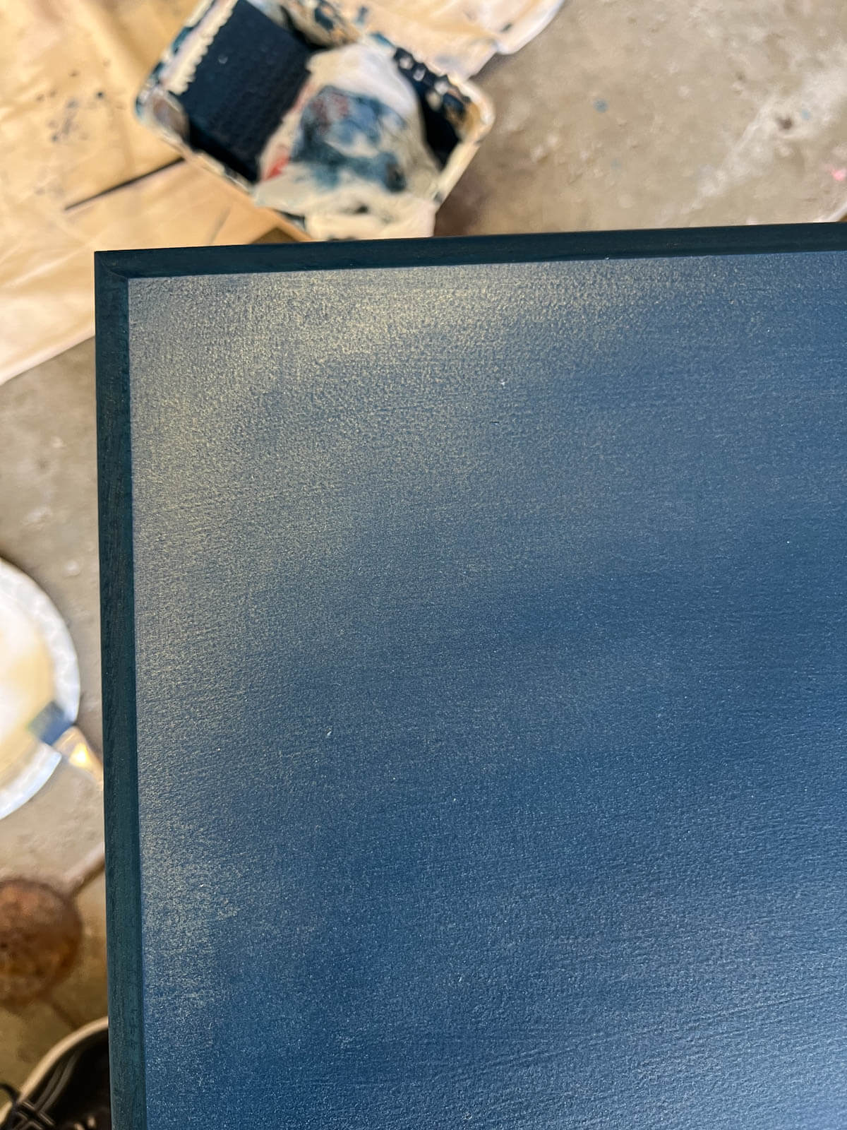 shiny blue layer on top of paint on desk door.