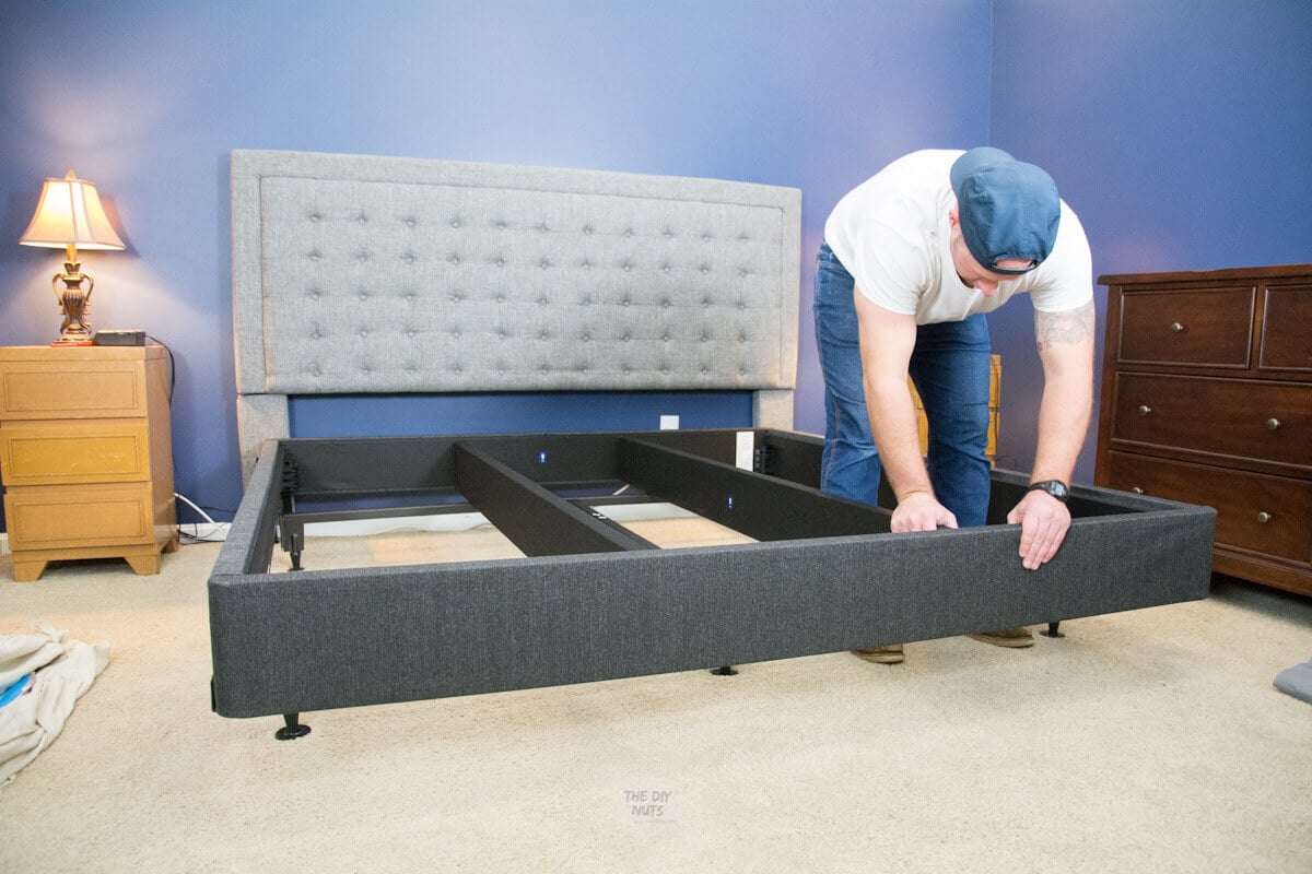 man putting together a bed frame.