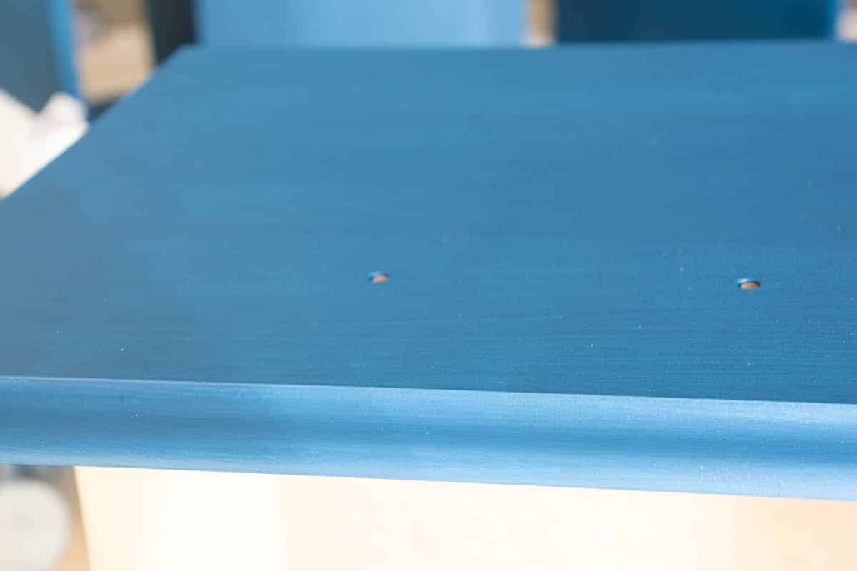 close-up of blue painted desk drawer.