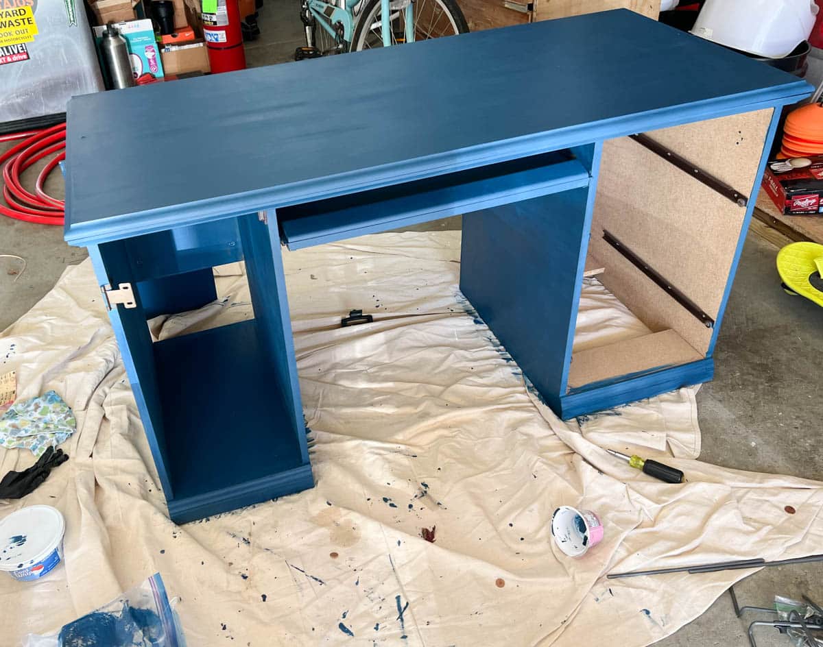 blue chalk painted desk without doors or drawers.