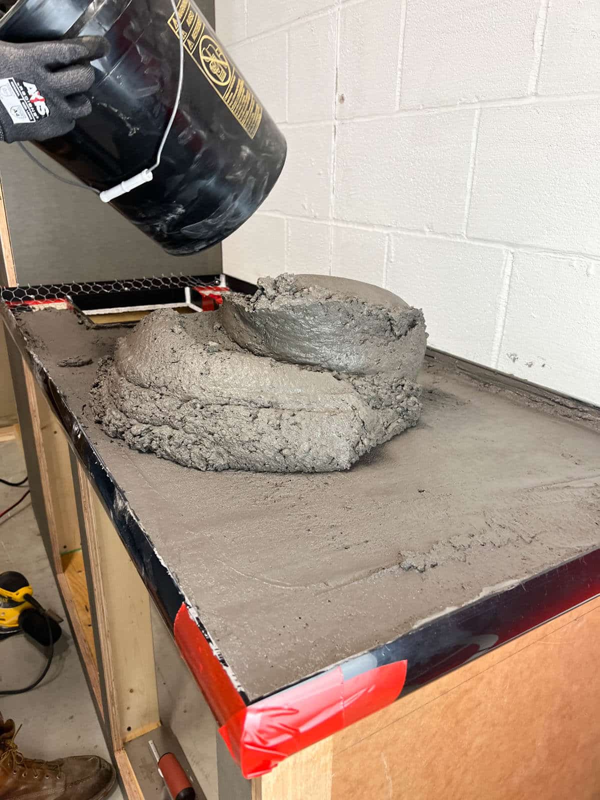 bucket pouring concrete on concrete countertops.